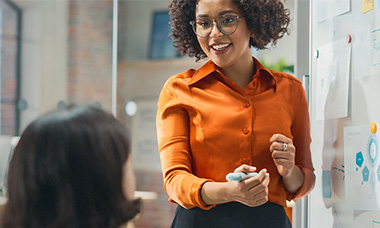 woman presenting from whiteboard