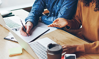 people writing with computers